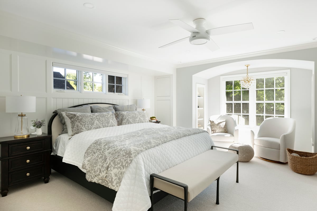 Bright bedroom with traditional white millwork details