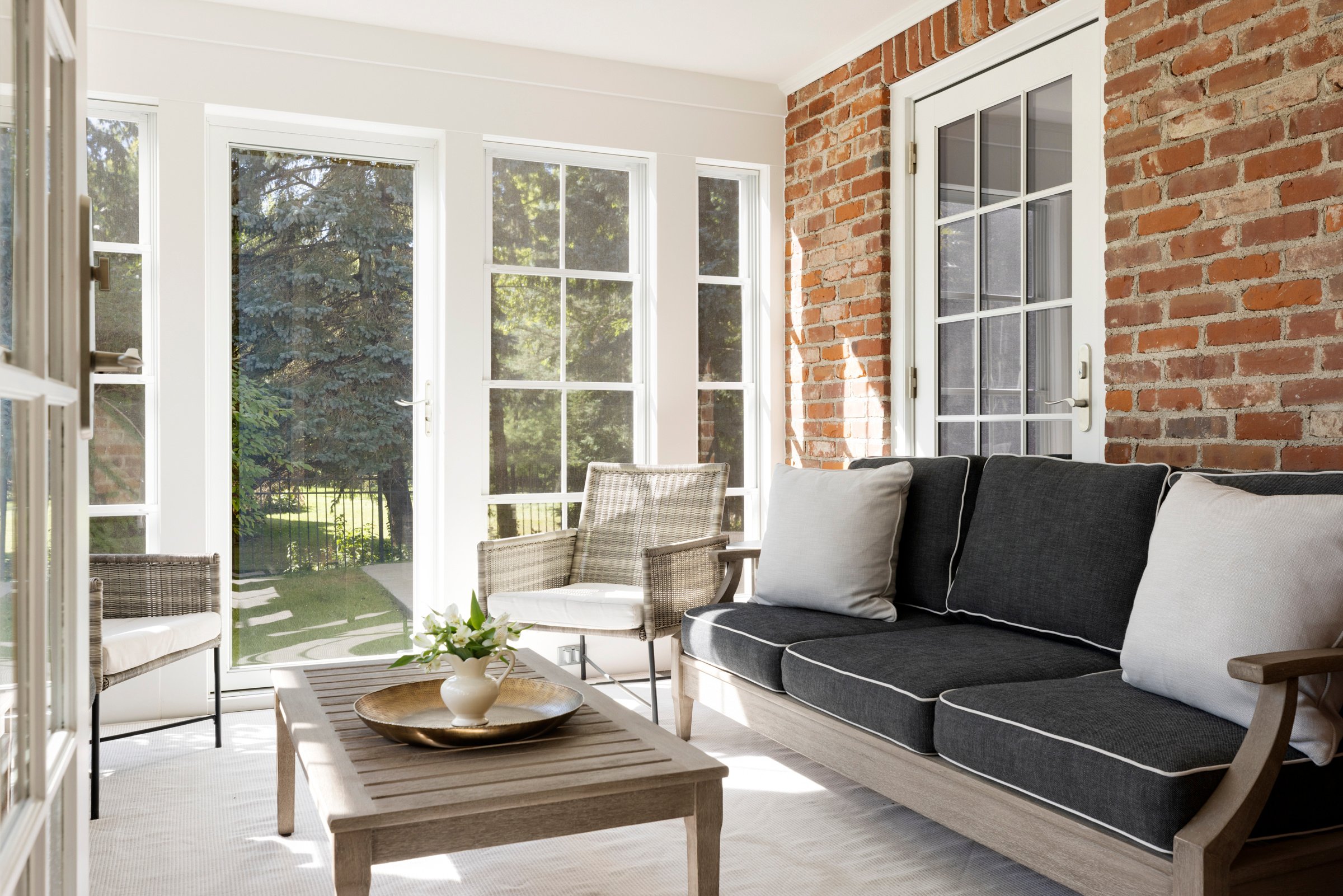 Remodeled three-season porch with new energy-efficient windows and natural wood ceiling.