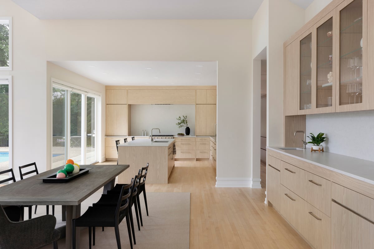 Modern kitchen, bar, dining room with warm details